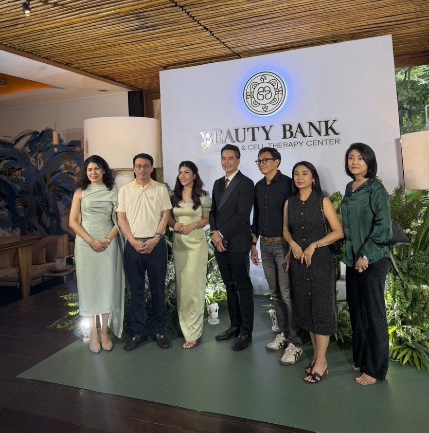 Founding partners and guests at the Beauty Bank Wellness & Cell Therapy Center opening, in front of the illuminated brand wall and the reception’s sculptural centrepiece.