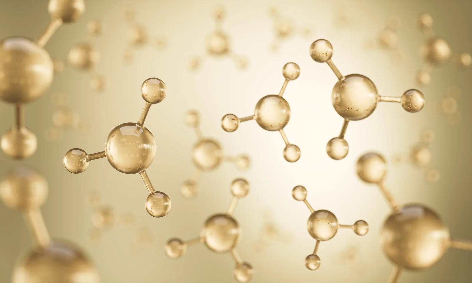 Golden molecular structures floating in soft light